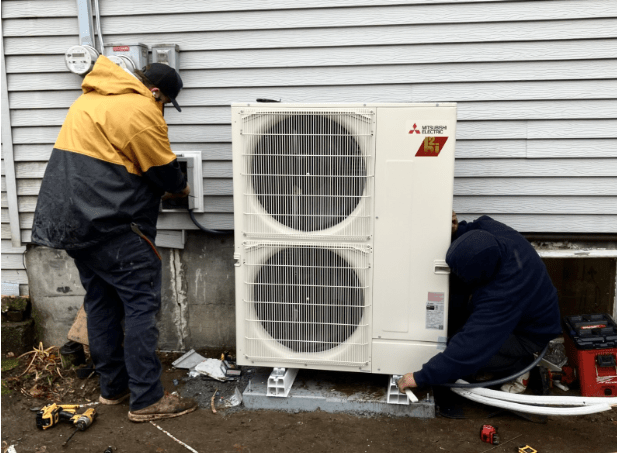 Contractor installing heat pump.